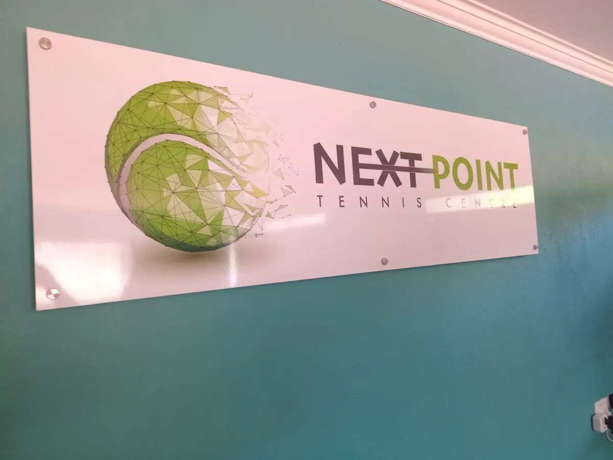 The NextPoint Tennis sign at the entrance to the courts