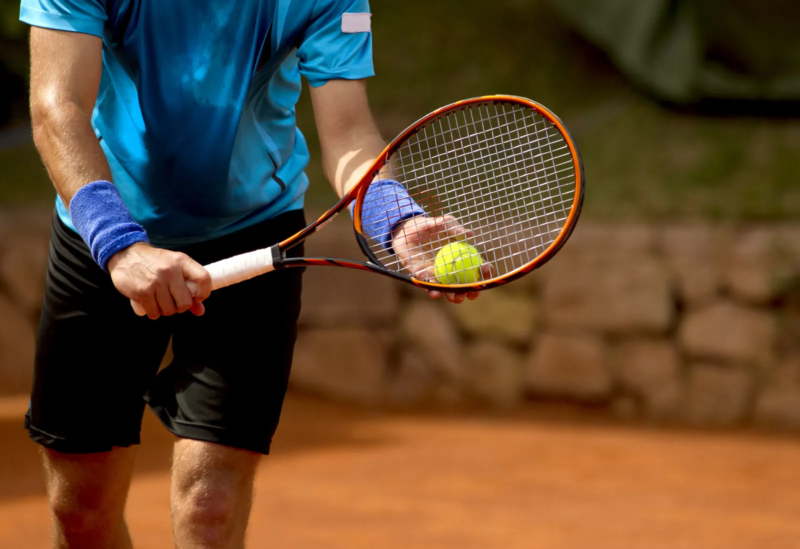 A player lines up a serve on clay during a High Performance training session