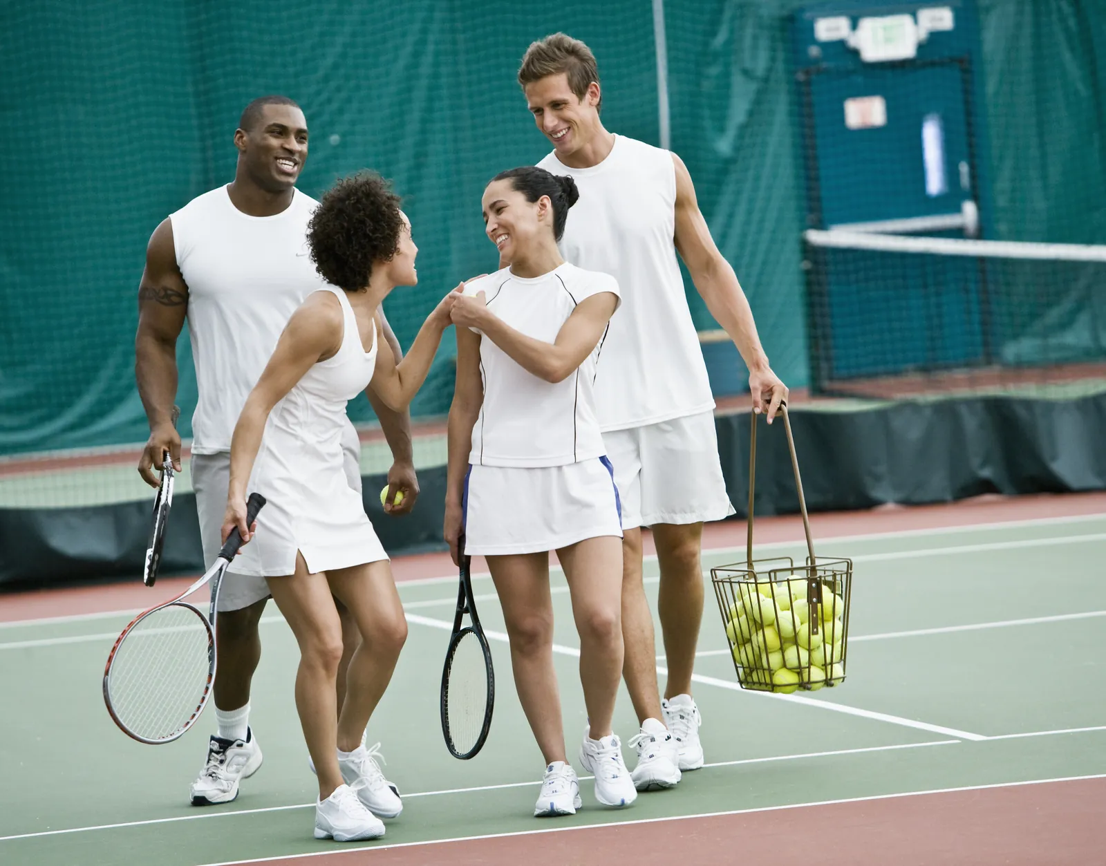 Members playing doubles on a resurfaced NextPoint hard court